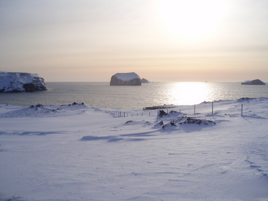 Calm sea, snow covered islands